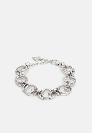 Zilveren kettingarmband met in elkaar grijpende ronde schakels met verhoogde "G"-letters en een driehoekige logo-tag met sluiting.