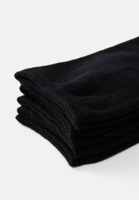 Black cotton socks stacked neatly, featuring a ribbed texture and smooth finish, demonstrating a simple and uniform design.