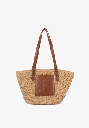 Sac fourre-tout en paille tissée avec des anses en cuir marron et une pièce de cuir assortie embossée du nom de la marque "Lancaster".