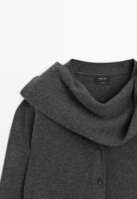 Dark gray wool cardigan with a wide, folded collar and black buttons down the front, laid flat on a white background.