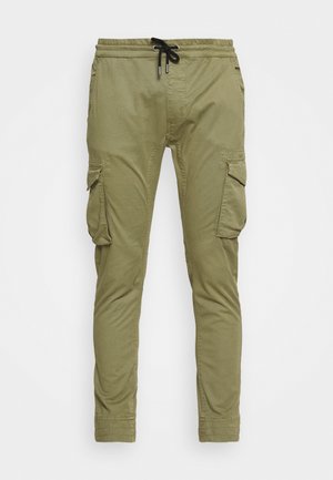 Cargo pants in olive green, featuring an elastic waistband with drawstring, tapered legs, two side pockets, and textured fabric.