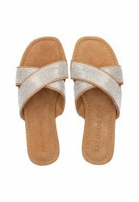 Brown suede slip-on sandals with crisscross rhinestone straps. Flat sole, cushioned footbed, minimalistic design, suitable for casual wear.