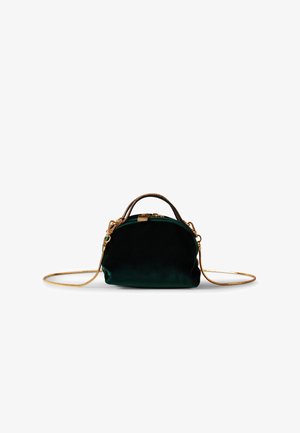 Green velvet handbag with a rounded shape, gold hardware, and a detachable chain strap. Features a small top handle and smooth texture.