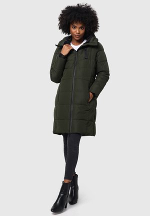 Green padded coat with a hood, featuring black accents, a front zipper, and side pockets. Worn with dark jeans and black ankle boots.