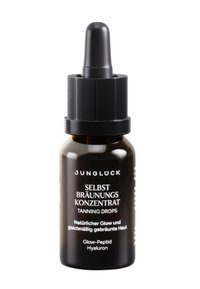 Dunkelbraune Glas-Tropfflasche mit dem Etikett "Junglück Selbstbräunungskonzentrat" - Bräunungstropfen für einen natürlichen Glow und einen gleichmäßigen Hautton.