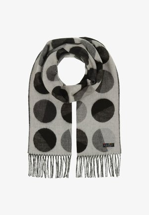 Siva šal s velikim crnim i sivim kružnim uzorcima. Mekana tekstura, resasti rubovi i mala oznaka brenda na jednom kraju.