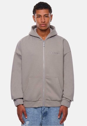 Gray zip-up hoodie made of cotton blend. Features a large hood, front pockets, ribbed cuffs, and embroidered logo on the chest.