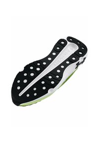 Semelle de chaussure avec un schéma de couleurs noir et blanc, surface en caoutchouc texturée, découpes circulaires pour une meilleure adhérence, et un accent vert sur le bord.
