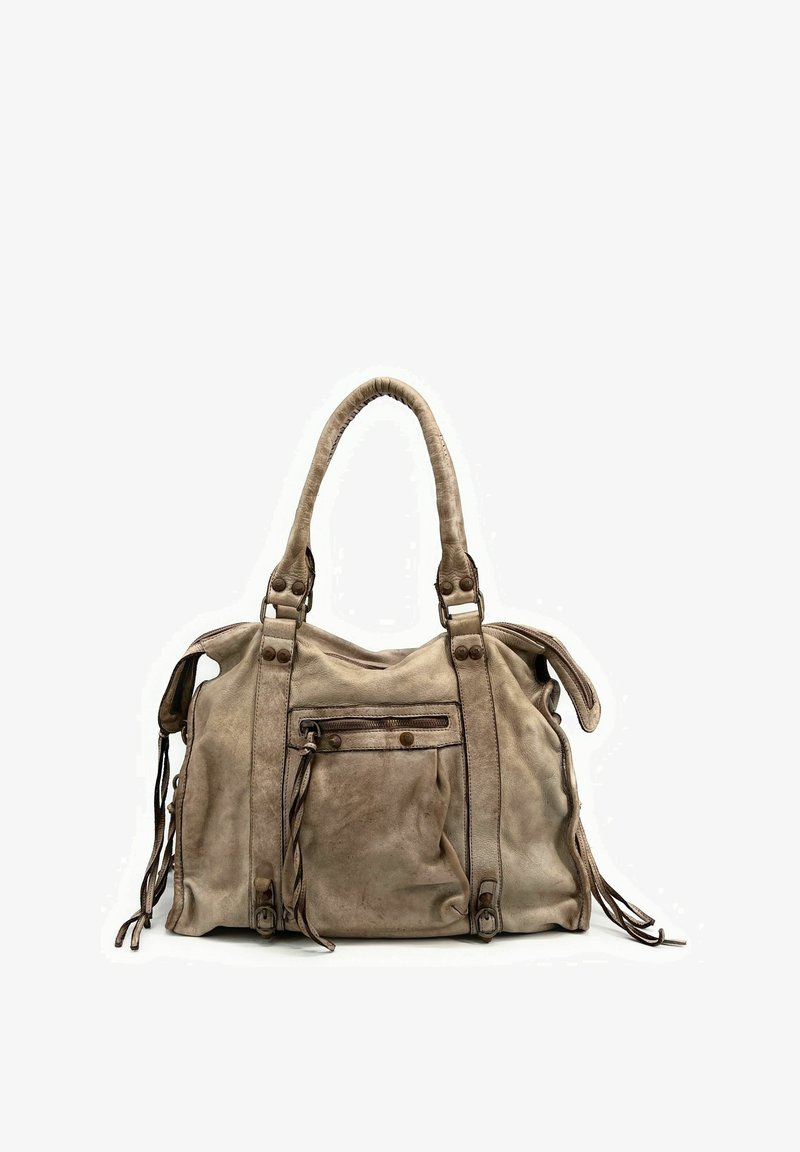 Sac à main en daim beige avec double poignée supérieure, poche avant zippée et accents en pompon. Présente une forme décontractée et un matériel contrastant brun.