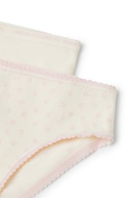 Intimo color crema con un motivo a pois, caratterizzato da una bordatura smerlata rosa e una banda con logo. Materiale in cotone morbido con una trama liscia.