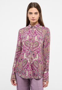 Long-sleeve blouse in patterned fabric with pink and gold paisley design, featuring a collar and button front closure. Soft texture.