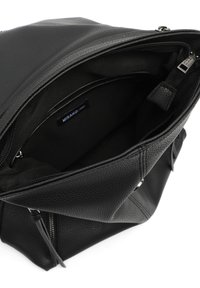 Black textured faux leather backpack with a zippered opening, featuring a soft fabric lining and brand label visible inside.