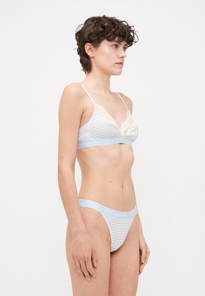 Blue and white striped bralette with lace detailing and thin straps, paired with matching thong featuring a light blue band with logo.
