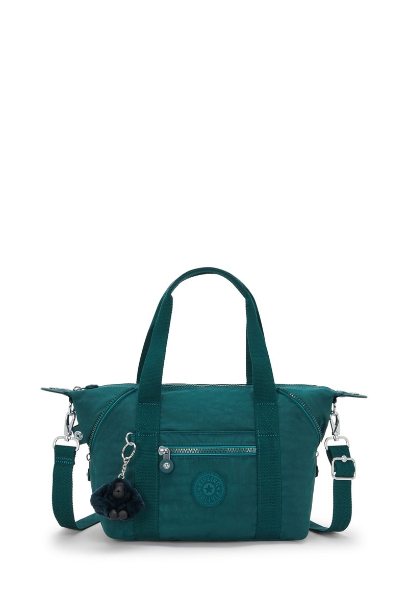 Teal fabric handbag with dual top handles, detachable shoulder strap, zip closure, front pocket, and furry keychain accessory.