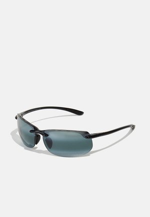 Sunglasses with a black frame, gray tinted lenses, and sleek design. Features curved edges and thin arms for a lightweight look.