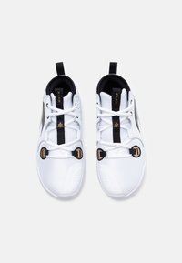 White sneakers featuring a smooth mesh upper, black accents, gold hardware, and a unique lacing system with two toggle closures.
