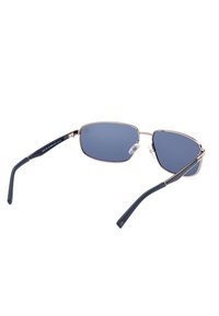 Occhiali da sole con una montatura in oro metallico, lenti con filtro blu e punte in plastica blu scuro sulle aste. Presentano cuscinetti nasali regolabili.
