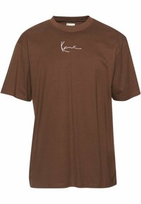 Camiseta de algodón marrón con mangas cortas, cuello redondo y un logo blanco en la parte delantera. Textura suave y corte relajado.