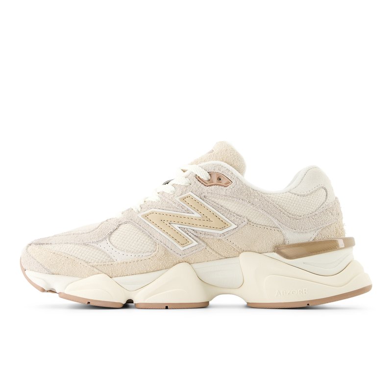 Scarpa sportiva beige e crema con tomaia in suede e mesh, suola spessa, logo "N" in evidenza e tallone imbottito per supporto.