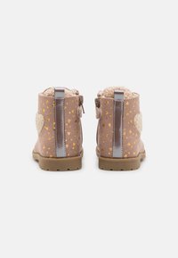 Stivaletti alla caviglia in suede rosa con motivo a cuori dorati, dettagli grigi, tacco peloso e chiusura con zip laterale. Suola in gomma per una buona aderenza.