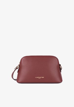 Maroon leather handbag with a rounded shape, gold-toned hardware, and embossed logo on the front. Adjustable shoulder strap included.