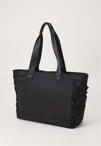 Black nylon tote bag with textured handles, side elastic details, and a small red accent. Rectangular shape, suitable for various everyday uses.