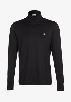 Schwarzes langärmeliges Rollkragen-Shirt mit kleinem weißem Lacoste-Krokodil-Logo auf der linken Brust, dargestellt auf einfachem weißem Hintergrund.