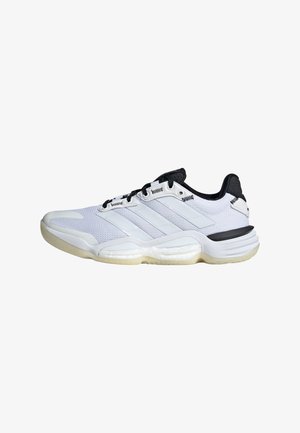 White athletic shoe with a mesh upper, rubber sole, and black accents. Features three white stripes on the side and a textured design.
