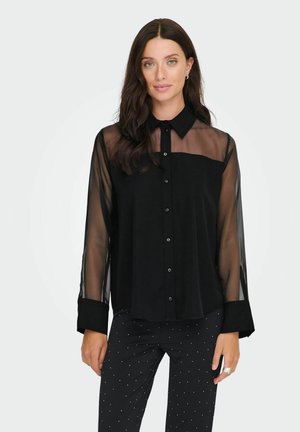 Zwarte button-up shirt met doorzichtige lange mouwen, een effen voorpand en een klassieke kraag. Het materiaal lijkt glad met een lichte glans.