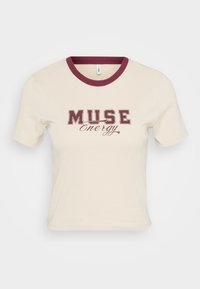 Short-sleeve cream t-shirt with a burgundy ribbed collar and "MUSE Energy" graphic in dark burgundy font centered on the front.