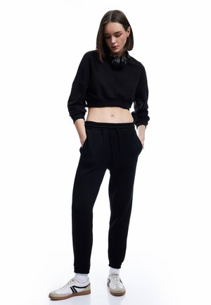 Pantalones deportivos - black