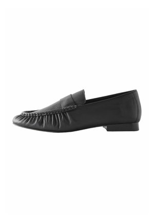 Black leather men's loafer with a low heel, pleated front detailing, and a smooth finish on the sides and back.