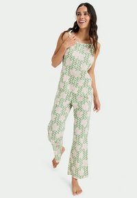 Overal s květinovým vzorem v světle zelené a růžové barvě. Obsahuje volný střih, široké nohavice a nastavitelné ramínka. Vyrobeno z lehkého materiálu.