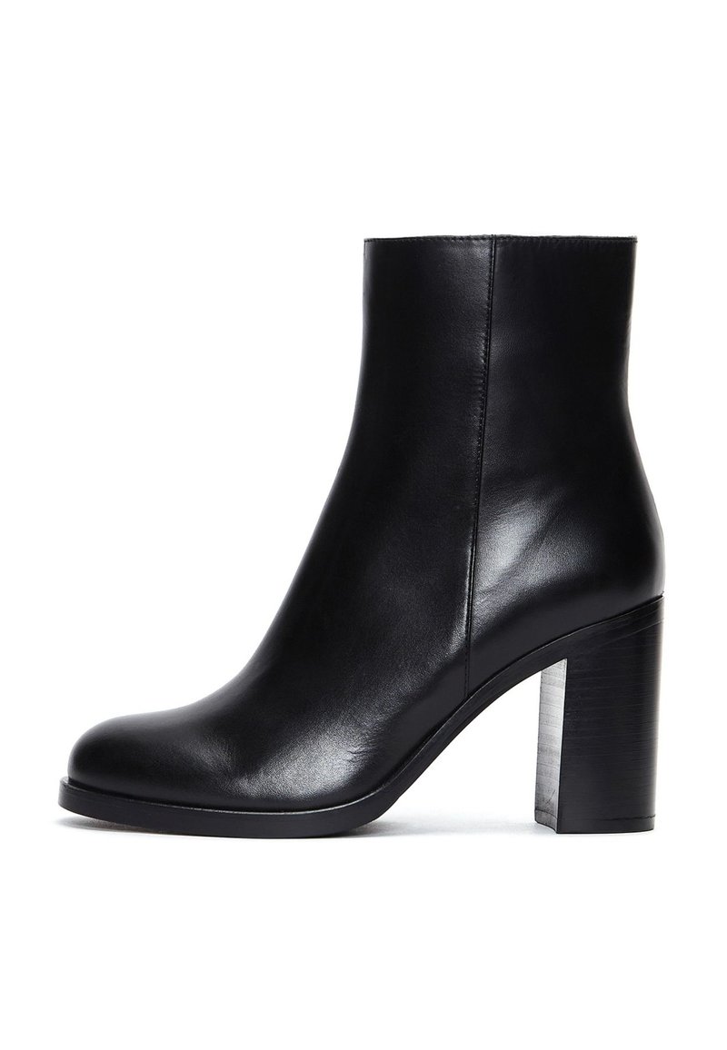 Black leather ankle boot with a rounded toe, smooth texture, and a thick, block heel. Sleek design with minimalistic detailing.