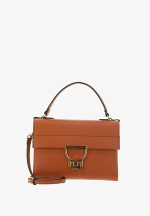 Sac à main en cuir fauve avec une poignée supérieure et une bandoulière amovible, doté d'une fermeture à boucle métallique dorée sur le devant.