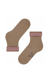 Chaussettes en coton beige avec un design côtelé et un accent rose au niveau du bord supérieur. Comprend un détail de logo sur la semelle.