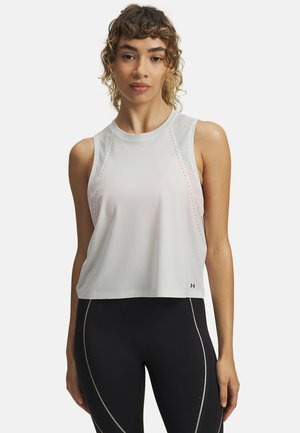 White athletic tank top with a cropped design, featuring mesh details on the shoulders and a smooth texture, paired with black leggings.