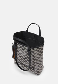 Gray and black patterned tote bag with a textured exterior, dual handles, and a zipper compartment inside. Features an orange logo tag.