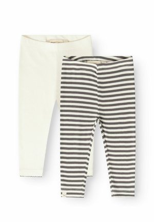 Deux paires de leggings bébé côtelés, un uni écru et un avec des rayures horizontales noires et blanches, présentés à plat sur fond blanc.