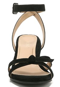 Black suede high-heeled sandal with an ankle strap, bow accent on the vamp, and a beige padded insole. Features open-toe design.
