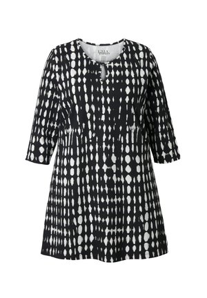 Zwart-witte tuniek met een overal stippenpatroon, ronde hals en driekwartmouwen. Gemaakt van lichtgewicht stof.
