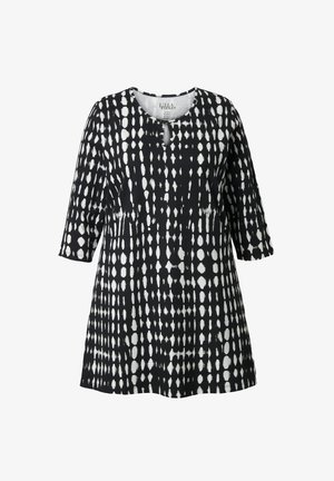 Tunika bianca e nera con motivo a pois su tutta la superficie, scollo rotondo e maniche a tre quarti. Realizzata in tessuto leggero.