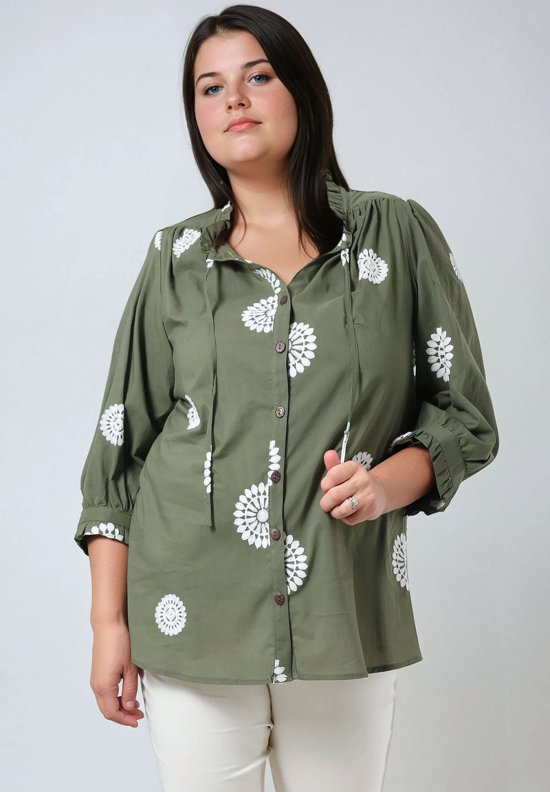 Olive green shirt with white floral embroidery, button-down front, and drawstring neckline. Features three-quarter sleeves and a relaxed fit.