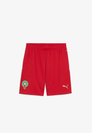 Kergedest sportlikud lühikesed püksid, mis on valmistatud kergest kangast. Omavad kuldset Puma logo ja tikitud Maroko embleemi vasakul jalal. Elastsest materjalist vöökoht koos taskutega.