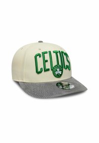 Celtics cap featuring a cream front and gray corduroy bill, with green embroidered text and logo details. Circular logo centered on front.