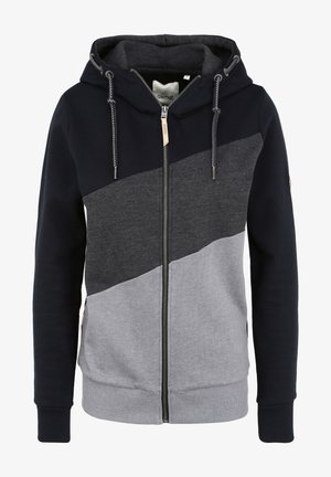 Kapuči un rāvējslēdzēju džemperis ar krāsu bloku dizainu tumši zilos, pelēkos un gaiši pelēkos tonī. Izgatavots no mīkstas auduma ar ribām aprocēm un apakšmalu.