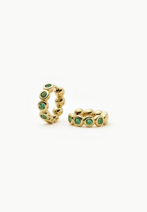 Gold hoop earrings with round green gemstones evenly spaced around the band, displayed on a white background.