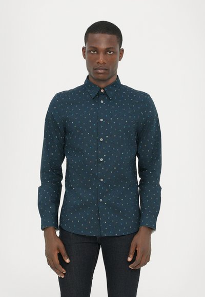 Dunkelblaue Button-down-Bluse mit einem sich wiederholenden geometrischen Muster in verschiedenen Farben. Lange Ärmel, Standardkragen und normale Passform.
