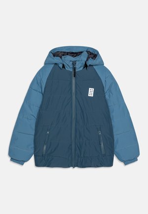 Blue padded hooded jacket with darker blue front and sleeves, full zip, two zippered pockets, and a small white patch on chest.
