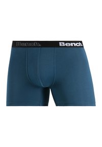 Blue stretch cotton boxer briefs with a fitted design. Black elastic waistband features white "Bench." logo. Soft texture, smooth seams.